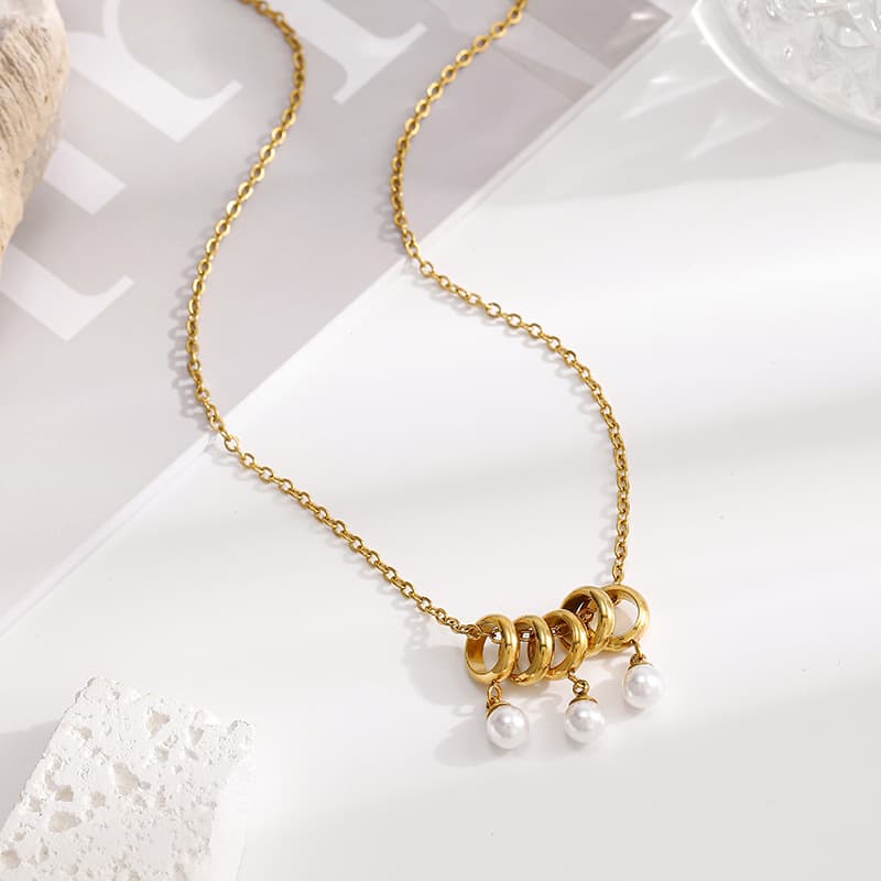 Geometric pearl necklace with minimalist design and luxurious teardrop pearl pendant. Multi-ring Pearl Necklace, detail image 2