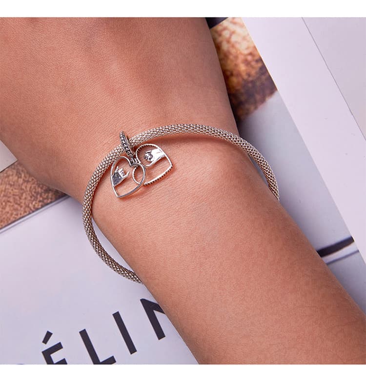 Hand-in-hand hollowed-out charm