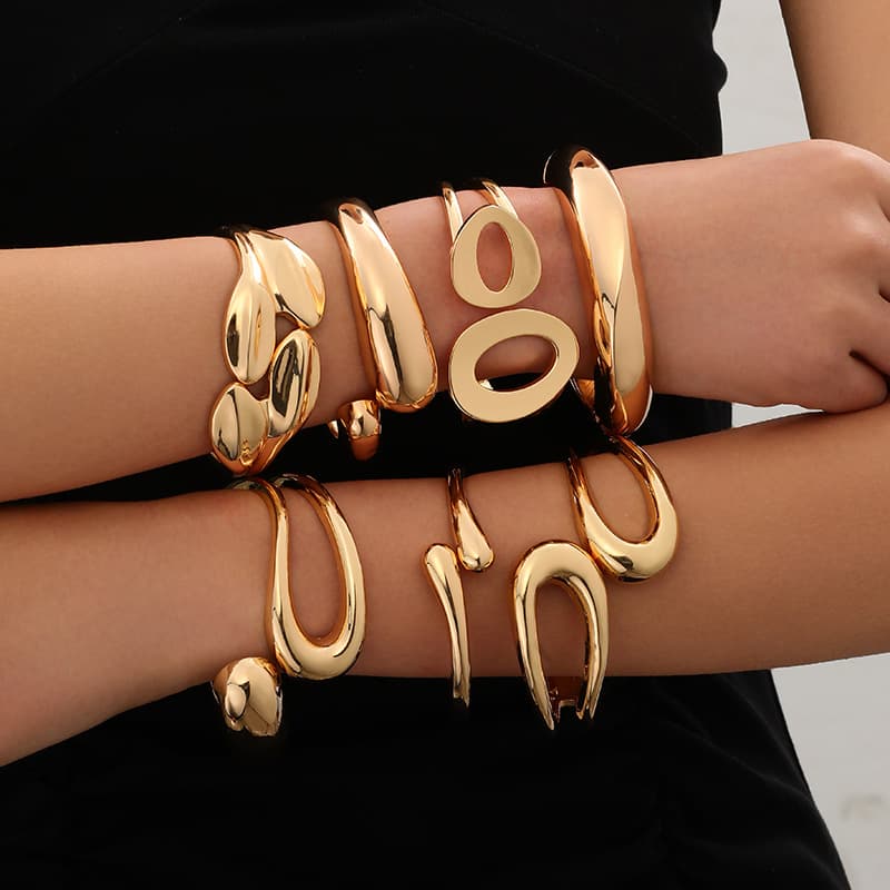 Minimalist irregular wave pattern metal bangle with a polished surface., detail image 2